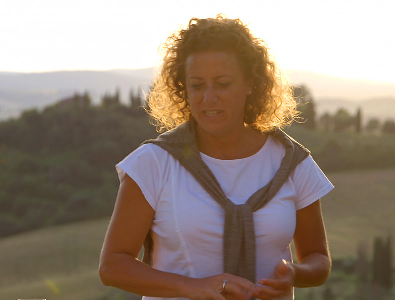 A lady standing in the Tuscan sunset
